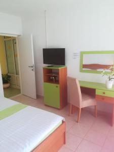 a room with a desk with a computer and a chair at Apartments Zvonimir in Hvar