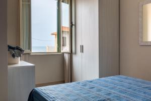 Posteľ alebo postele v izbe v ubytovaní Happy Sea Home Monolocale Angolo Cottura 4 pax