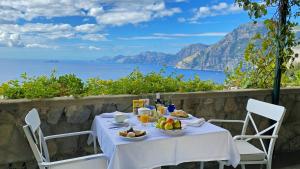 a table with food and a view of the ocean at Grand Hotel Tritone in Praiano