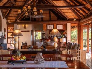 a kitchen and living room with a table and chairs at Tintswalo Waterberg in Vaalwater
