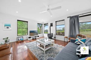 a living room with a couch and a tv at iyla Estate in Pokolbin