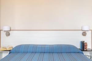 Posteľ alebo postele v izbe v ubytovaní Happy Sea Home Monolocale Angolo Cottura 4 pax