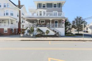 a large white house with a balcony on a street at Large Patio with Ocean Views Beach Block Parking Unit 3 in Ventnor City