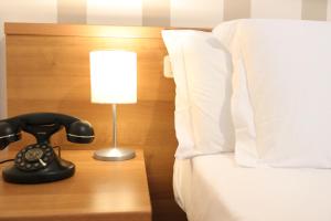 Letto o letti in una camera di Hotel Castel Miramonti