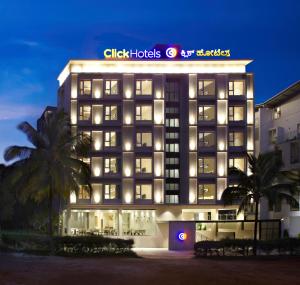 a hotel with a sign on the side of a building at Click Hotel Bangalore - International Airport in Devanahalli-Bangalore