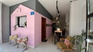 a living room with a pink wall at Live in Athens, PSYRRI Central Apartments in Athens