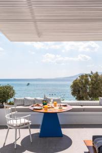 
a table with chairs and a table cloth on it at Santana Beach in Agia Anna Naxos
