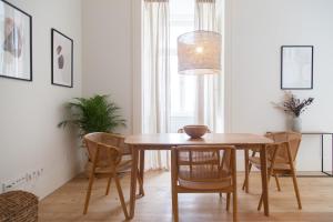 a dining room with a wooden table and chairs at FLH Praça Comércio Bright Flat in Lisbon