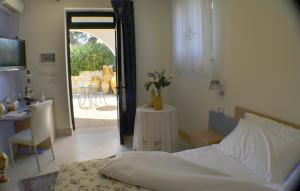 a bedroom with a bed and a table with a tableablish at Masseria Asciano in Ostuni