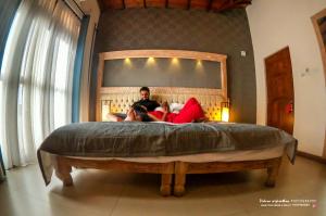 a man and a woman sitting on a bed at Rivora Residence in Kandy