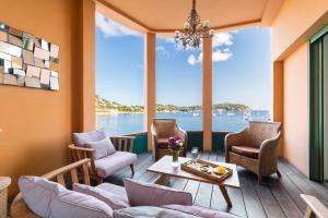 a living room with a view of the water at MY CASA - LES MARINIÈRES - 100m2 Panoramic View AC - Villefranche-sur-Mer in Villefranche-sur-Mer