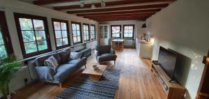 a living room with a couch and a fireplace at Ferienwohnung auf idyllischen Gestüt auf historischen Gutshof in Hessen in Bad Hersfeld