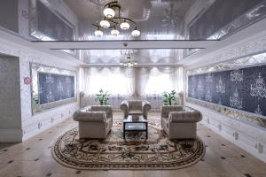 a living room with two chairs and a table at Hotel Orenburg in Orenburg