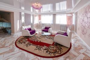 a living room with two chairs and a table at Hotel Orenburg in Orenburg