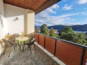 a balcony with a table and chairs and a view at Appartements Diana in Millstatt