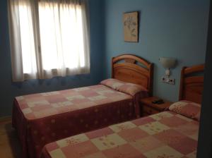 Łóżko lub łóżka w pokoju w obiekcie Hostal Los Amigos