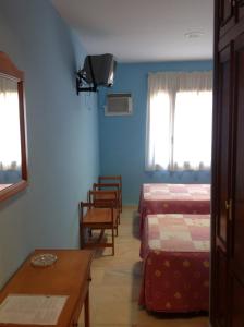 Łóżko lub łóżka w pokoju w obiekcie Hostal Los Amigos