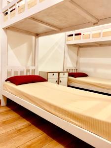 two bunk beds in a room with wooden floors at Easy Hostels in Panaji