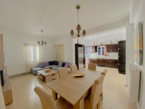a dining room and kitchen with a table and chairs at Sifneiko Arxontiko in Faros