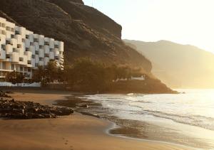 a view of a beach with buildings and the ocean at Beach hideaway apartment with modernist design in Santa Cruz de Tenerife