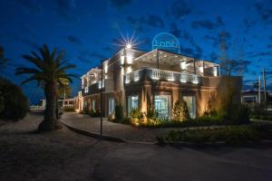 a house with a light on top of it at night at Tabù Hotel in Porto Cesareo