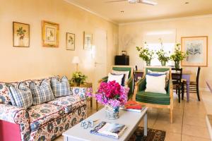 a living room with a couch and a table at Cornerway House in Plettenberg Bay
