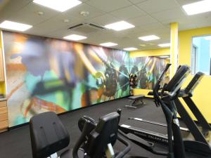 a gym with cardio machines and a large painting on the wall at Best Western Plus The Inn at Hells Canyon in Clarkston