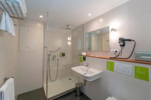 a bathroom with a sink and a shower at ARTIEM Carlos - Adults Only in Es Castell