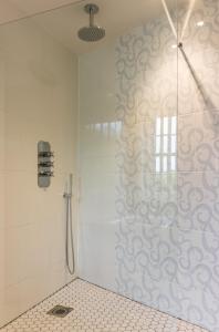 a shower with a glass door in a bathroom at Newby Bridge Hotel in Newby Bridge