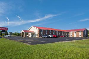 a large building with a parking lot in front of it at Econo Lodge Inn & Suites in Escanaba