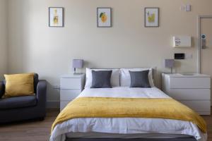 a bedroom with a large bed and a couch at Hereford City Centre - Apartment 6, Isabella House - Modern Apartment In The Heart of The City - Sleeps 4 Guests - Hosted by RENTMYHOUSE in Hereford +3 photos