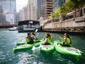 a group of people riding on kayaks in the water at 21c Museum Hotel Chicago in Chicago