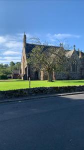 a church sitting on the side of a road at The Clachan Flat in Rosneath