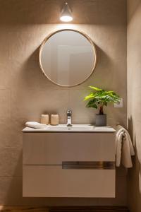 a bathroom with a sink and a mirror at MH Apartments Central Sevilla in Seville +101 photos