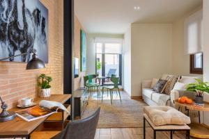 a living room with a couch and a table at MH Apartments Central Sevilla in Seville