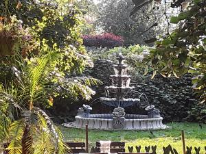 a fountain in the middle of a garden at Gästezimmer in Lindenau in Leipzig