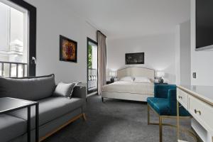 a living room with a bed and a couch at The Square Hotel in Cluj-Napoca