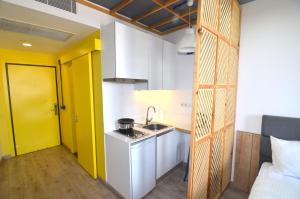 a small kitchen with a sink in a room at Coordinat Suits in Izmir