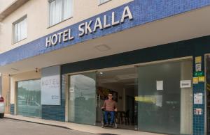 Un hombre está montando una moto afuera. en Hotel Skalla, en Teixeira de Freitas