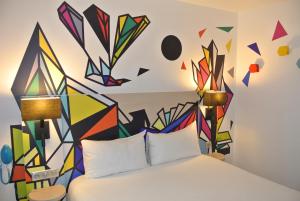 a painting of a wall with a bunch of colorful kites on it at ibis Styles Paris Maine Montparnasse in Paris