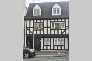 a black and white house with a car parked in front at Potters Court A Hidden Gem in Tewkesbury