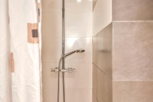 a shower with a glass door in a bathroom at Ghat Apartments Montroig in Sitges