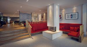 a living room filled with furniture and a red carpet at Kimpton De Witt Amsterdam, an IHG Hotel in Amsterdam