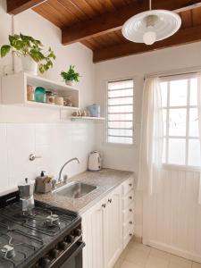 a kitchen with a sink and a stove at Loft Amarillo in Tandil