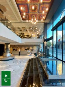 a lobby of a building with a pool in it at Hotel América Sevilla in Seville