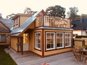 a house with a deck and a balcony at Ryytlihaus Old Town Apartement in Haapsalu