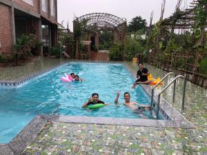 a group of people in a swimming pool at Bầu Bí Mini Farmstay Mekong - Tiền Giang in Mỹ Tho