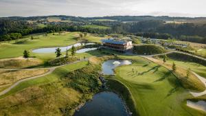 an aerial view of a golf course with a building at Panorama Golf Resort in Kácov