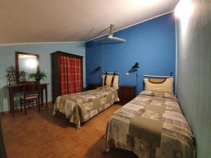 A bed or beds in a room at Bio Agriturismo Valle dei Calanchi