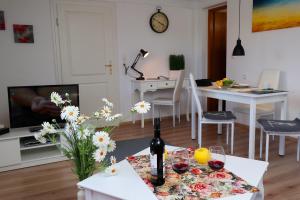 a living room with a table with a bottle of wine at Landhaus-Vintage, Fe-Wo Apartment 3 in Schluchsee
